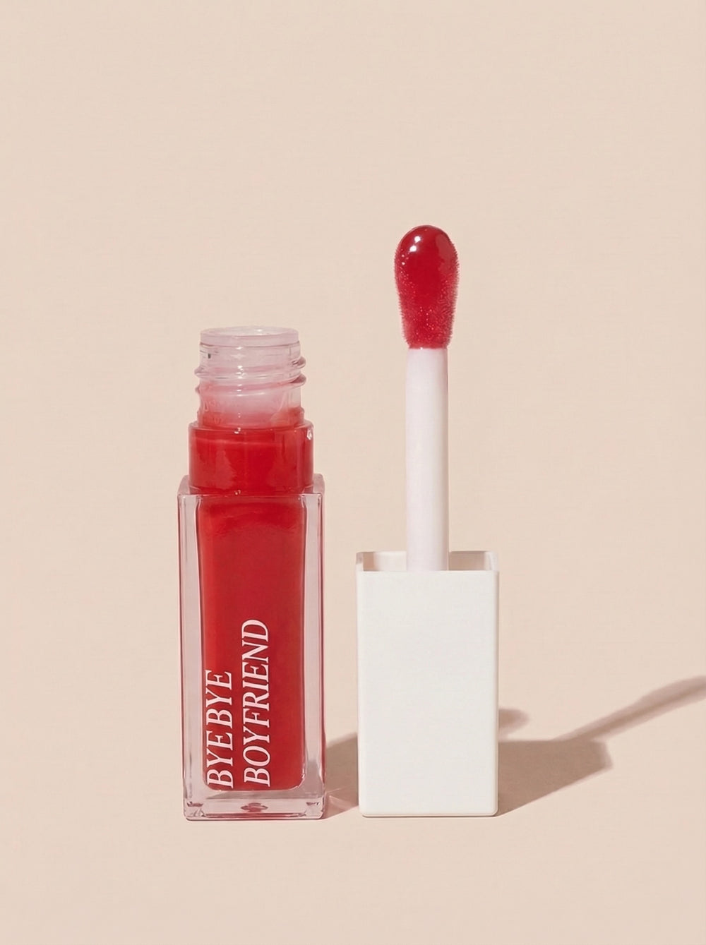 Deep cherry lip gloss stain for 90s editorial makeup look.